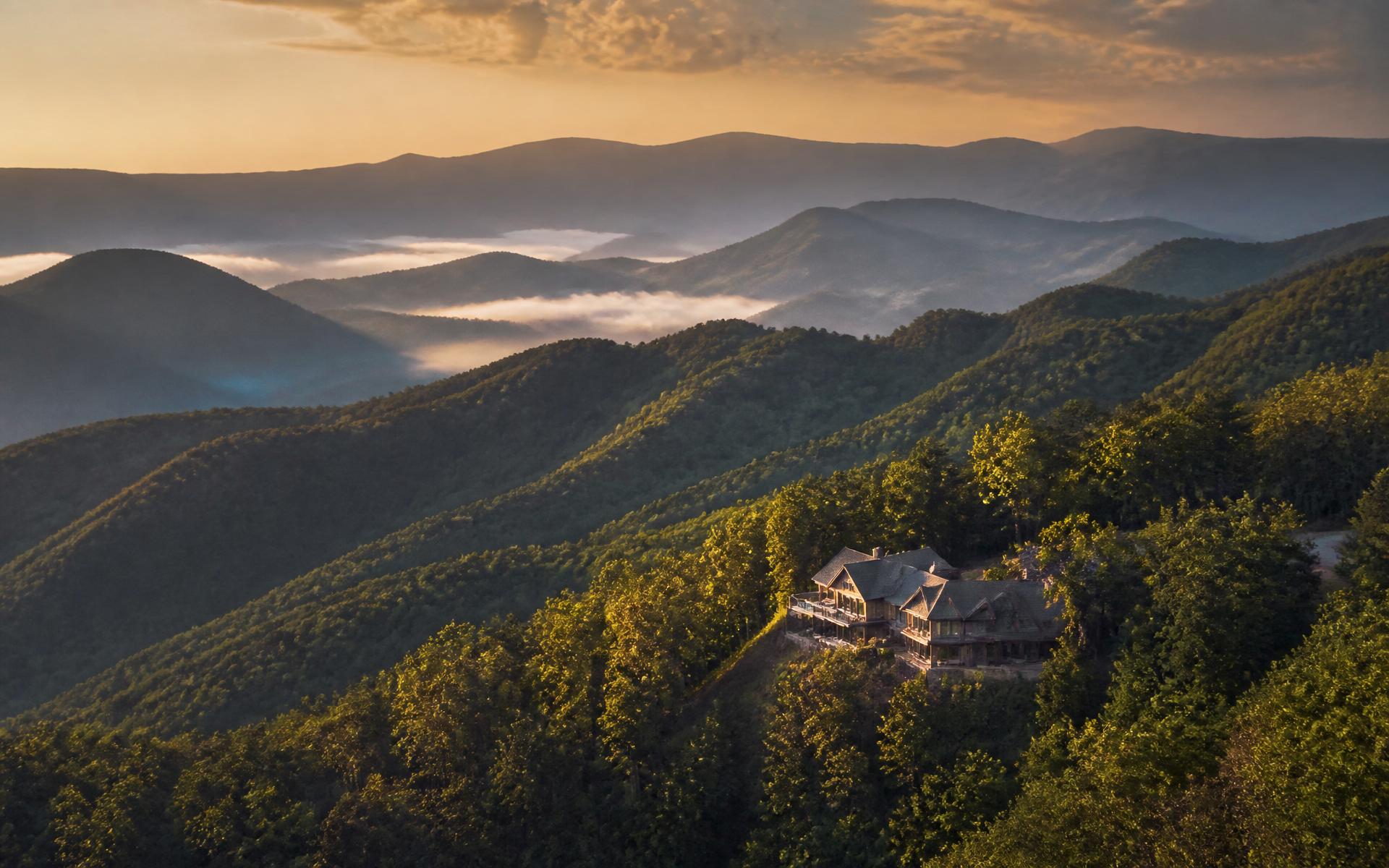 Great Smoky Mountains at golden hour with a luxury home overlooking the ridges